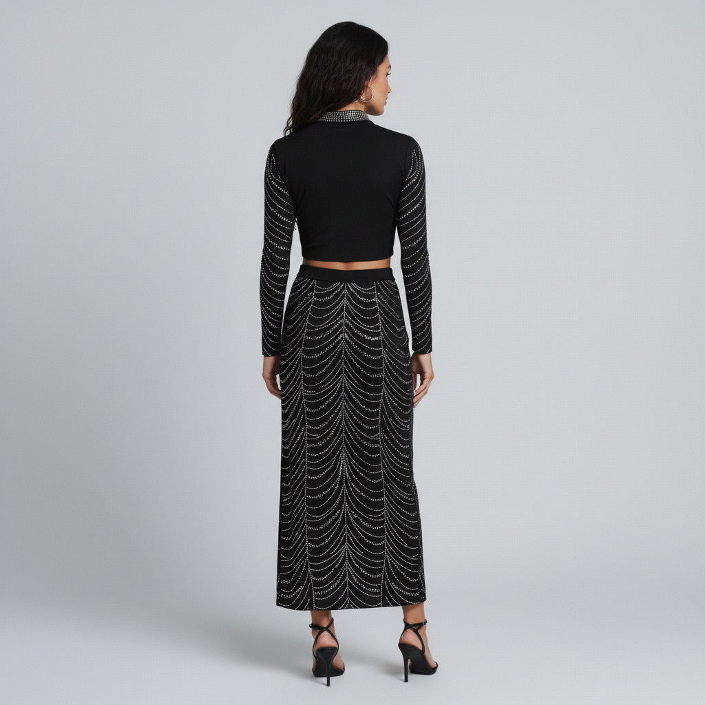 Black studded two-piece set with long-sleeve crop top and maxi skirt