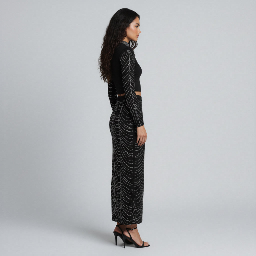 Black studded two-piece set with long-sleeve crop top and maxi skirt