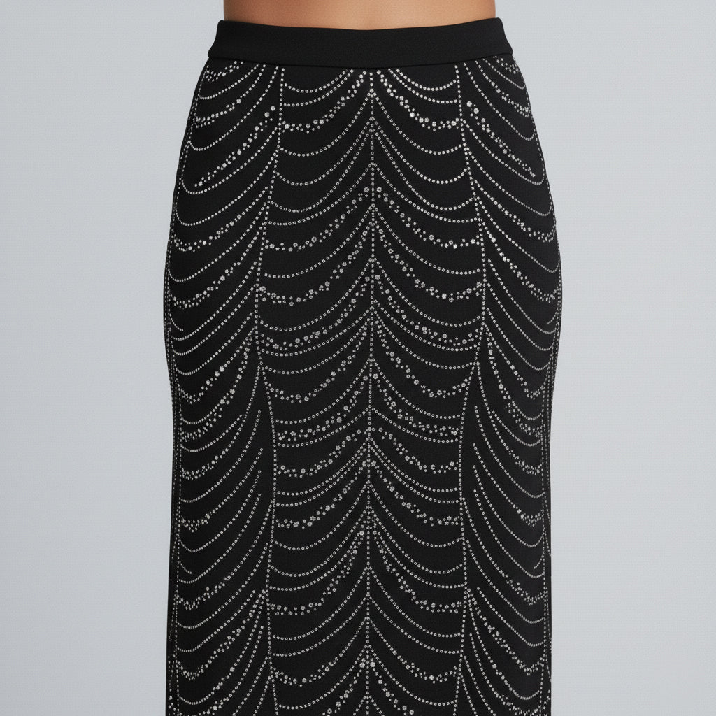 Black studded two-piece set with long-sleeve crop top and maxi skirt