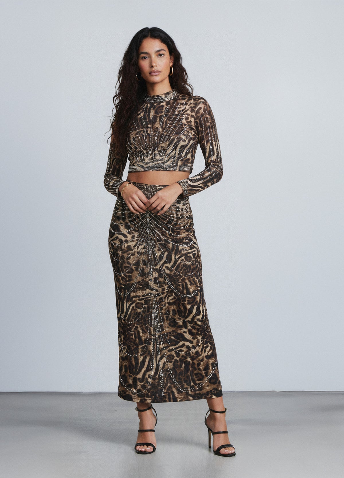 Animal-print crop top and maxi skirt with intricate beadwork. Statement evening set for parties, galas, and holiday events.